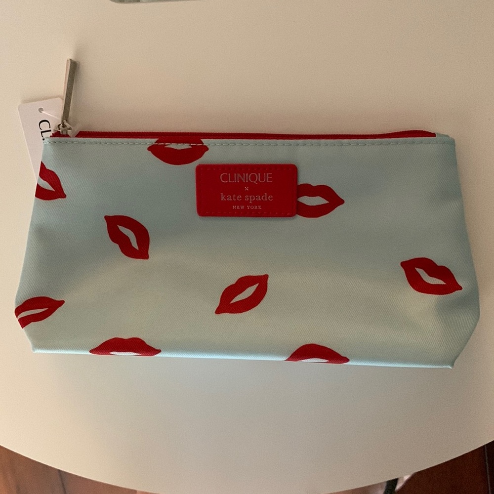 Light blue Kate Spade make up bag with red kisses